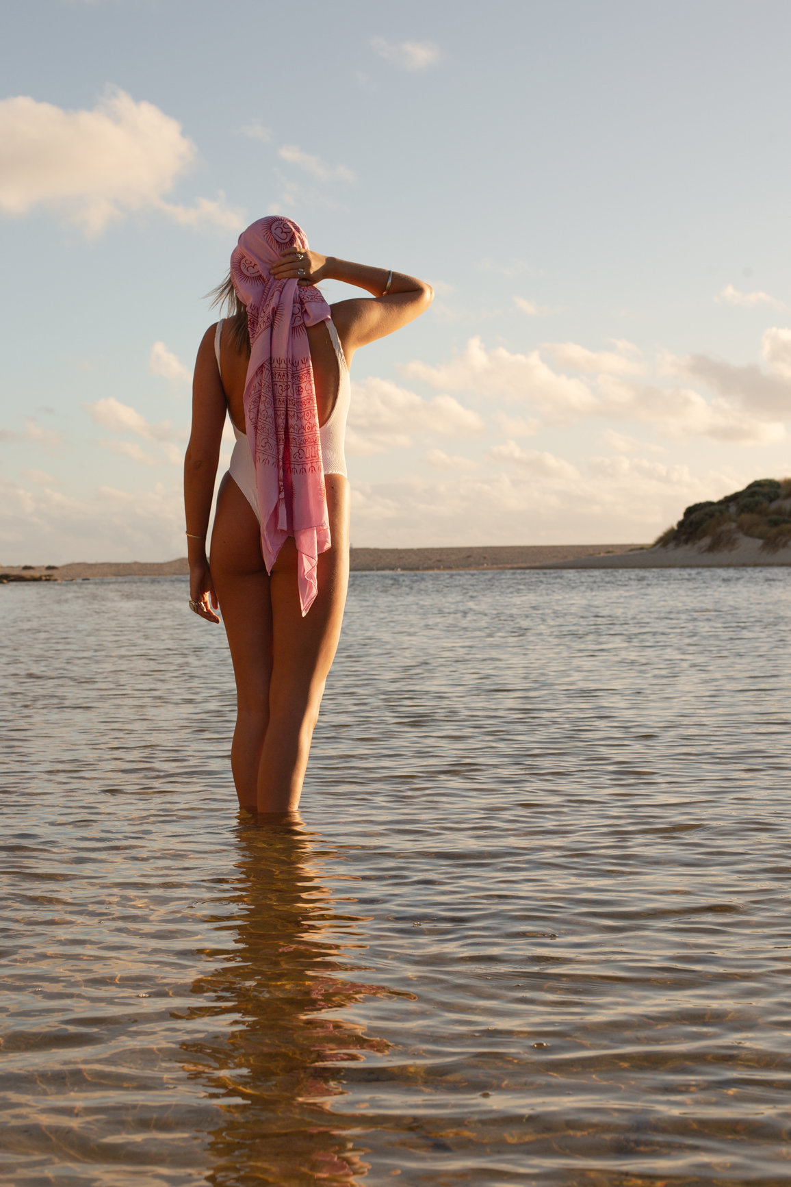 Person in swimsuit standing in shallow water 